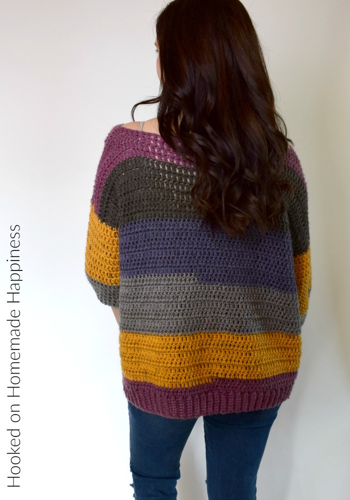 Everygirl Crochet Sweater Pattern - This comfy, easy to make Everygirl Crochet Sweater is the perfect addition to your fall wardrobe. I used 2 Caron Cakes to make this sweater. When picking out my skeins, I made sure to find ones that had the same starting color so the stripes on the front and back out (almost) match up.