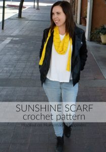Sunshine Crochet Scarf Pattern - Let the warm sunshine in with this Sunshine Crochet Scarf Pattern! It's made with a super lightweight cotton and that makes it perfect for warmer weather. It hangs loose around the neck so you don't have to worry about getting too warm with this scarf.