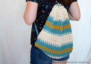 Daytrip Cinch Backpack Crochet Pattern - The Daytrip Cinch Backpack Crochet Pattern is perfect for your next outing! It's made of durable cotton, with a solid stitch, and can hold all the things you might need. #crochet #freecrochetpattern #crochetbag