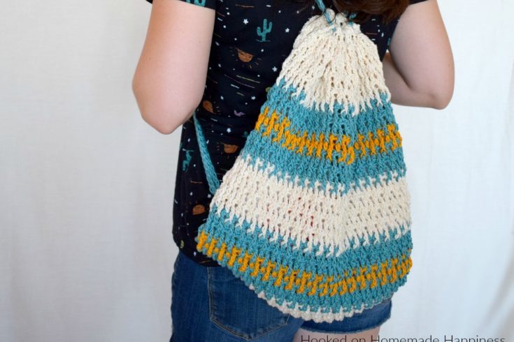 Daytrip Cinch Backpack Crochet Pattern - The Daytrip Cinch Backpack Crochet Pattern is perfect for your next outing! It's made of durable cotton, with a solid stitch, and can hold all the things you might need. #crochet #freecrochetpattern #crochetbag