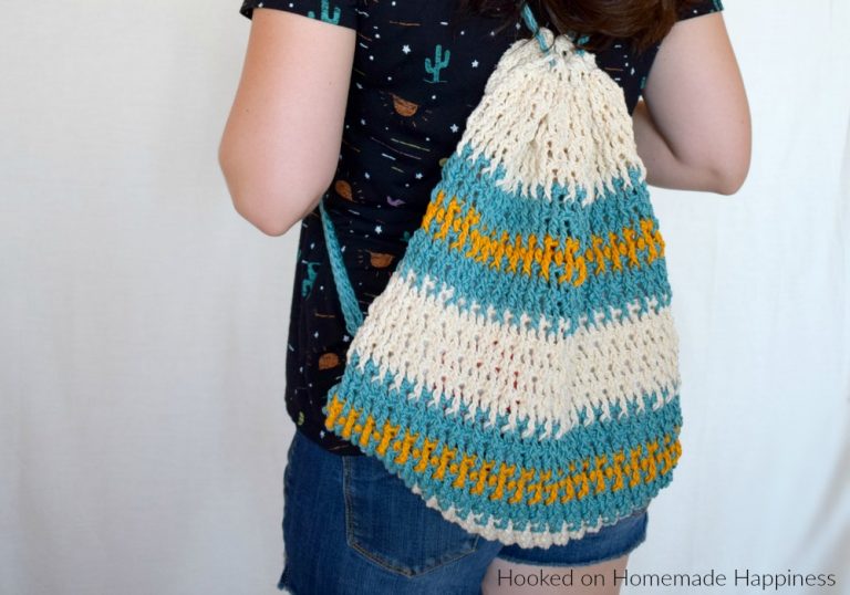 Daytrip Cinch Backpack Crochet Pattern - The Daytrip Cinch Backpack Crochet Pattern is perfect for your next outing! It's made of durable cotton, with a solid stitch, and can hold all the things you might need. #crochet #freecrochetpattern #crochetbag