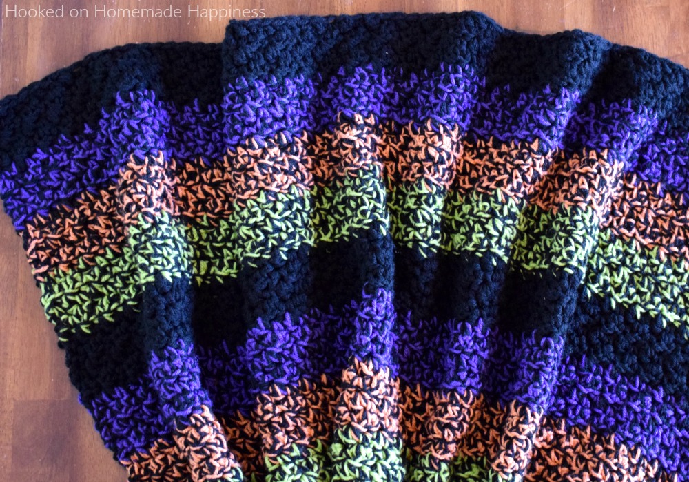 Easy Halloween Blanket Crochet Pattern - It's almost Halloween time and you can have this Easy Halloween Blanket Crochet Pattern ready just in time for the festivities to begin! By using double strands the blanket is a quick project that is really warm and snuggly.