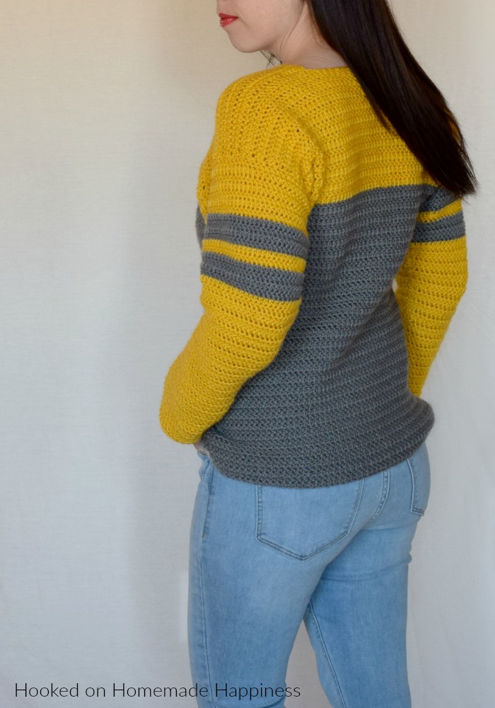 Tailgate Sweater Crochet Pattern - The Tailgate Sweater Crochet Pattern is a lightweight sweater that can easily be customized to show off your favorite team! But of course you can just choose a favorite color combination (like I did :) ) There are so many things I love about this sweater. The slight v neck, the color blocking, the stripes on the sleeves, the DK weight yarn... So. Many. Things.