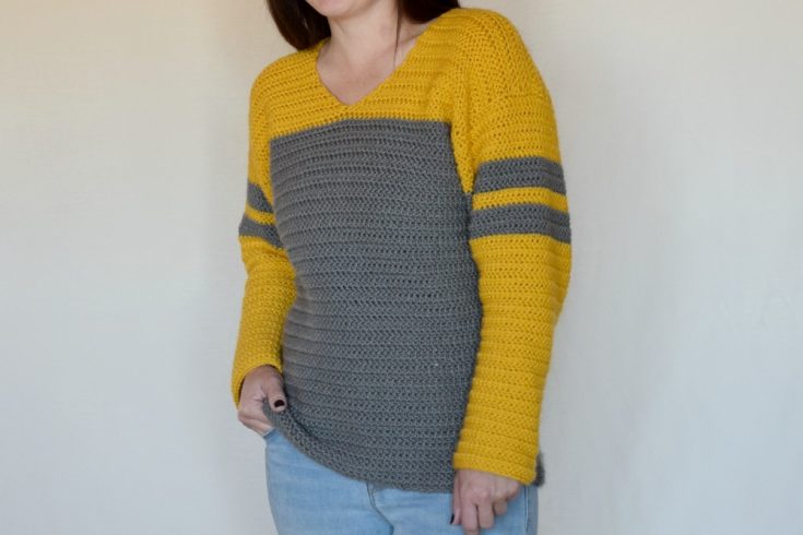 Tailgate Sweater Crochet Pattern - The Tailgate Sweater Crochet Pattern is a lightweight sweater that can easily be customized to show off your favorite team! But of course you can just choose a favorite color combination (like I did :) ) There are so many things I love about this sweater. The slight v neck, the color blocking, the stripes on the sleeves, the DK weight yarn... So. Many. Things.