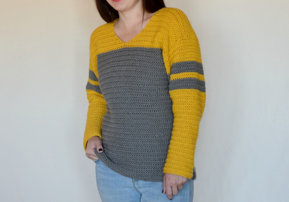 Tailgate Sweater Crochet Pattern - The Tailgate Sweater Crochet Pattern is a lightweight sweater that can easily be customized to show off your favorite team! But of course you can just choose a favorite color combination (like I did :) ) There are so many things I love about this sweater. The slight v neck, the color blocking, the stripes on the sleeves, the DK weight yarn... So. Many. Things.