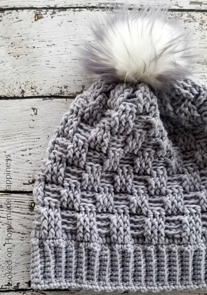 Woven Beanie Crochet Pattern - The Woven Beanie Crochet Pattern uses the basket weave stitch to create this pretty woven look. I love all the different textures of this beanie with the ribbed brim, the basket weave, and the fun pom pom.
