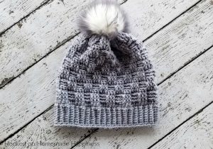 Woven Beanie Crochet Pattern - The Woven Beanie Crochet Pattern uses the basket weave stitch to create this pretty woven look. I love all the different textures of this beanie with the ribbed brim, the basket weave, and the fun pom pom.