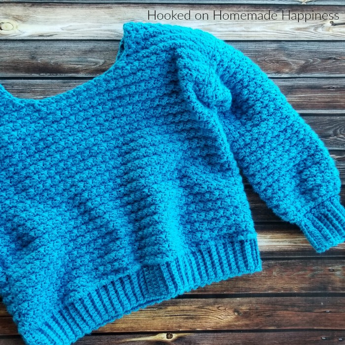 Cozy Cropped Sweater Crochet Pattern - The Cozy Cropped Sweater Crochet Pattern is made with one of my favorite stitches, the Suzette Stitch! It creates a sturdy and beautiful texture. Because of the tight stitch, this little sweater is surprisingly warm and cozy!