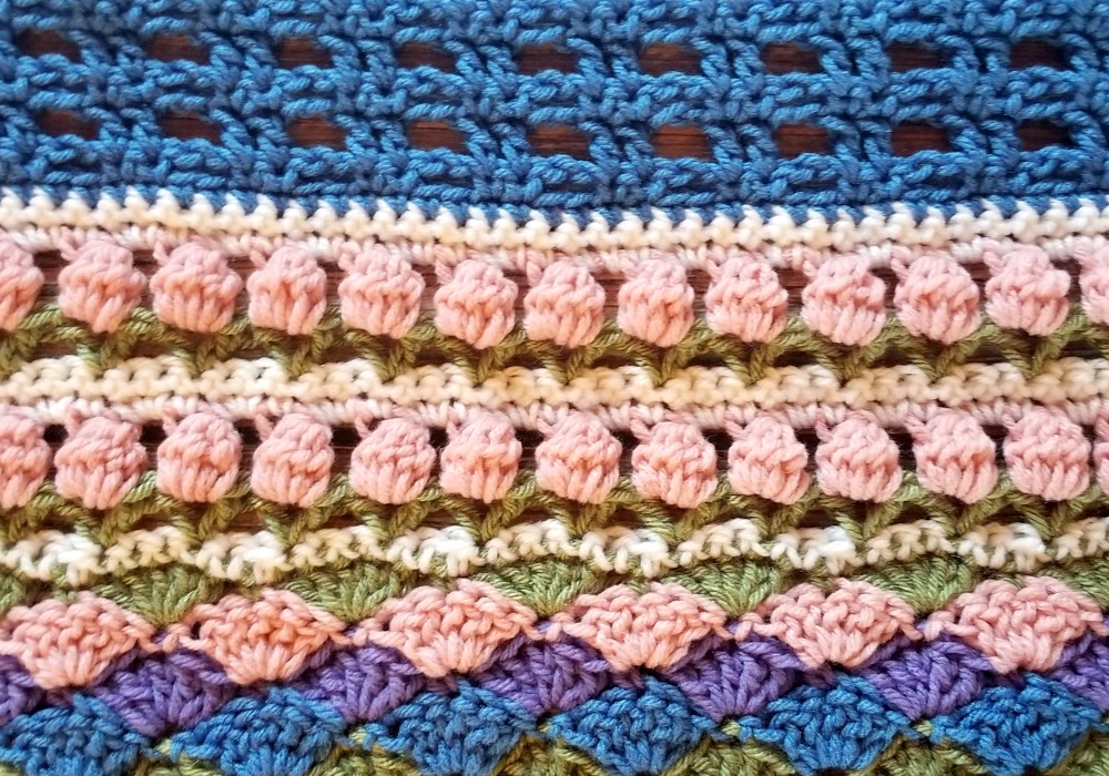 Welcome to Part 14 of the Stitch Sampler Scrapghan CAL! Only a couple weeks left until we’re all done! This week is the Tulip Stitch. It’s a repeat of a stitch we did earlier in the blanket.