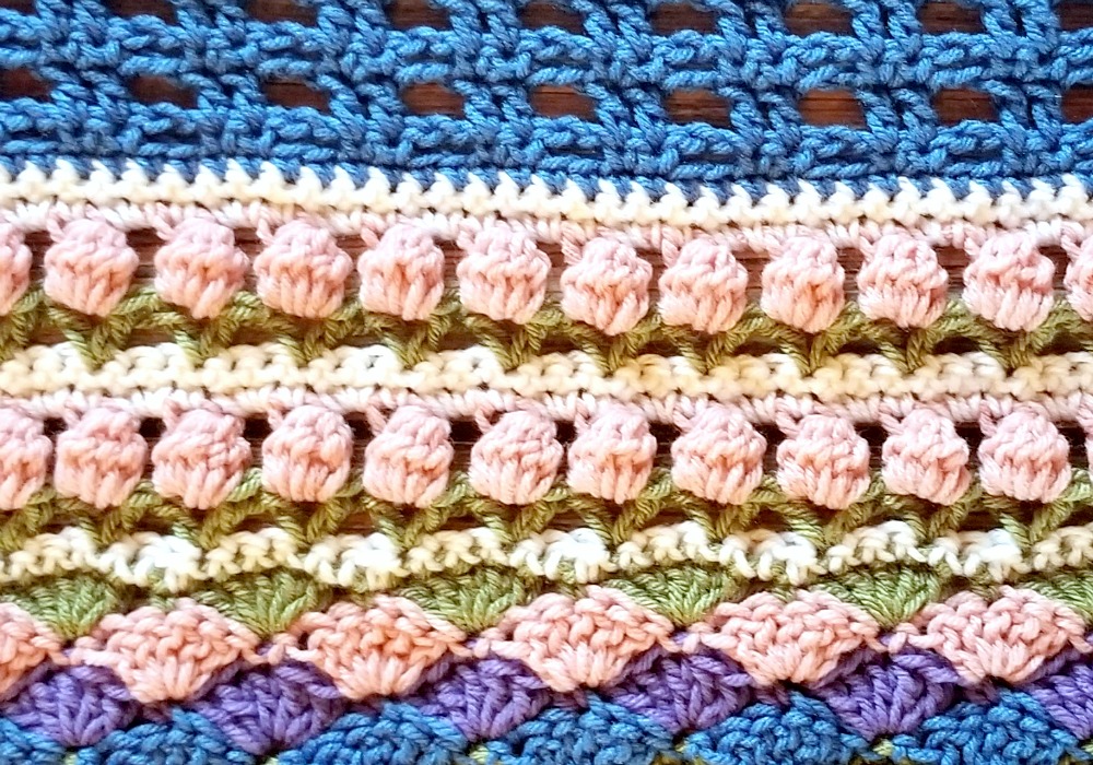 Welcome to Part 14 of the Stitch Sampler Scrapghan CAL! Only a couple weeks left until we’re all done! This week is the Tulip Stitch. It’s a repeat of a stitch we did earlier in the blanket.