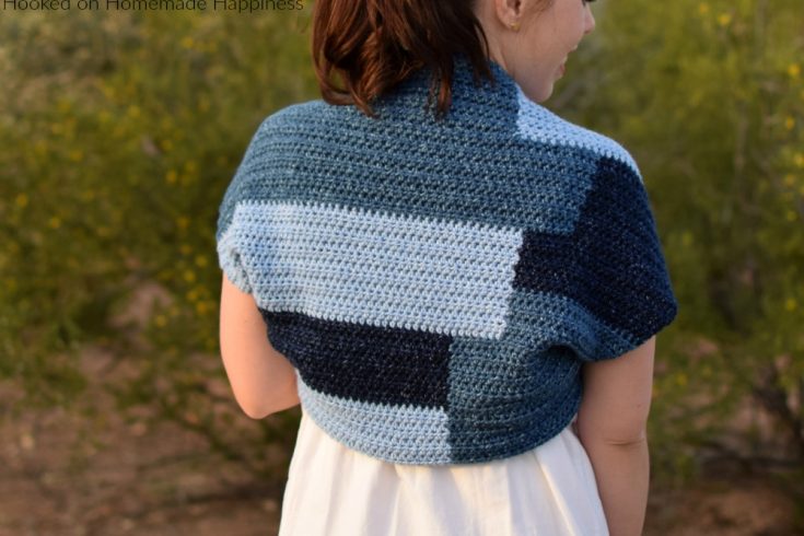 Patchwork Shrug Crochet Pattern - The fun design in this Patchwork Shrug Crochet Pattern is made as one piece! It's one rectangle with a little bit of sewing to make the shrug shape.