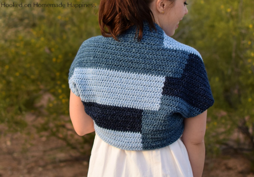 Patchwork Shrug Crochet Pattern - The fun design in this Patchwork Shrug Crochet Pattern is made as one piece! It's one rectangle with a little bit of sewing to make the shrug shape.