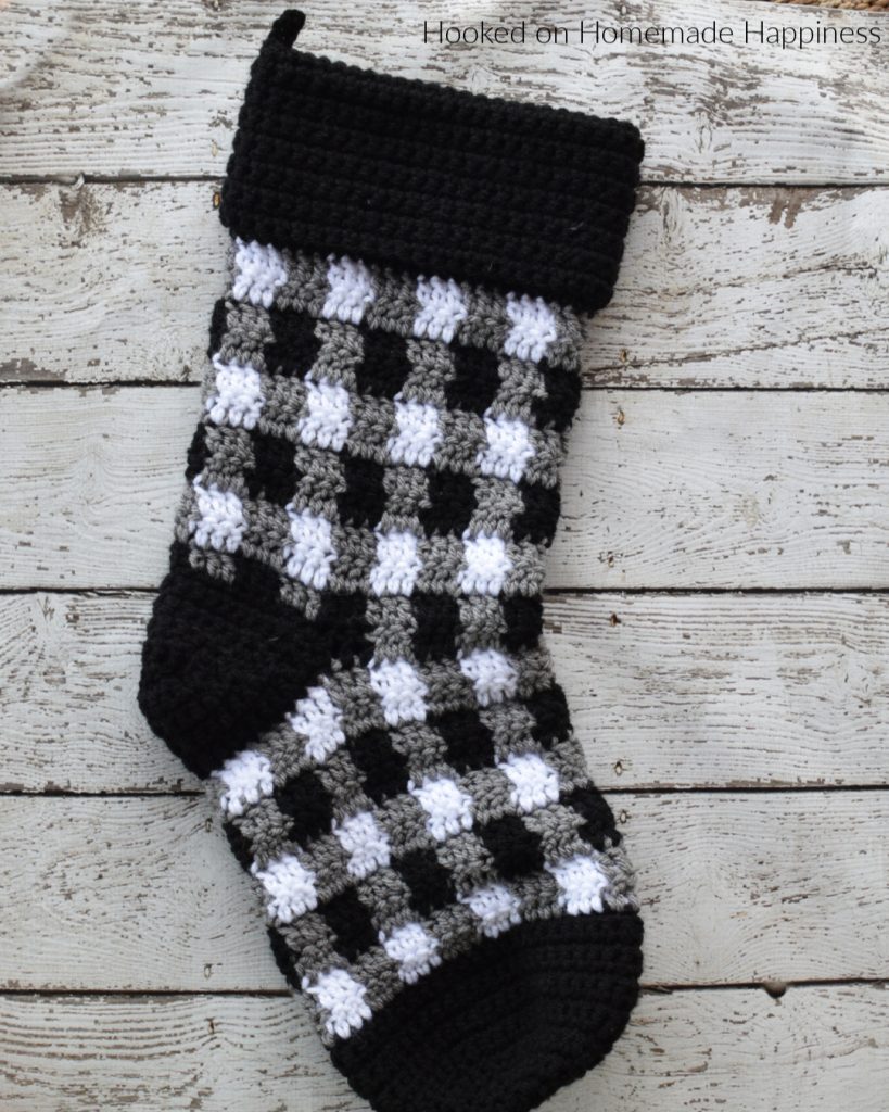 Plaid Crochet Stocking Pattern - This Plaid Crochet Stocking Pattern is so festive and cute! Because of the bulky weight yarn, it works up surprisingly fast. This stocking is a good size and can hold LOTS of goodies from Santa!