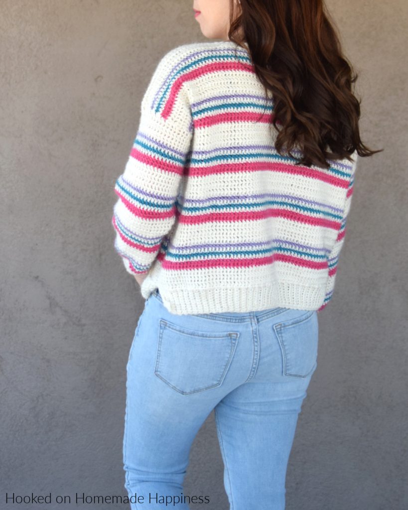 Pulled Taffy Pullover Crochet Pattern - The Pulled Taffy Pullover Crochet Pattern is a lightweight sweater that is perfect for fall and spring. It would also be fun for the holiday season! The stripes would be so cute in Christmas colors.