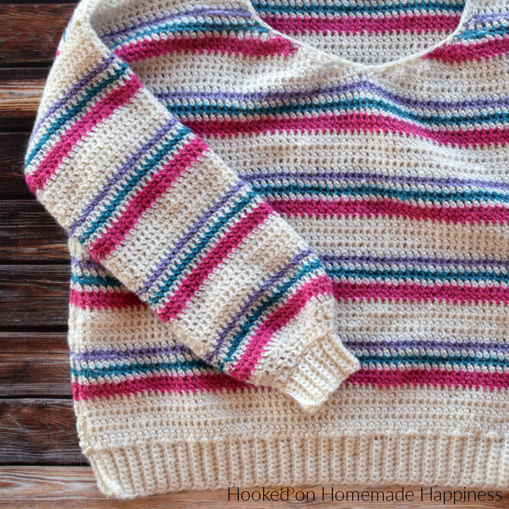 Pulled Taffy Pullover Crochet Pattern - The Pulled Taffy Pullover Crochet Pattern is a lightweight sweater that is perfect for fall and spring. It would also be fun for the holiday season! The stripes would be so cute in Christmas colors.