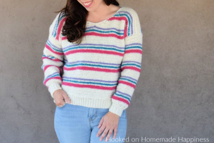 Pulled Taffy Pullover Crochet Pattern - The Pulled Taffy Pullover Crochet Pattern is a lightweight sweater that is perfect for fall and spring. It would also be fun for the holiday season! The stripes would be so cute in Christmas colors.