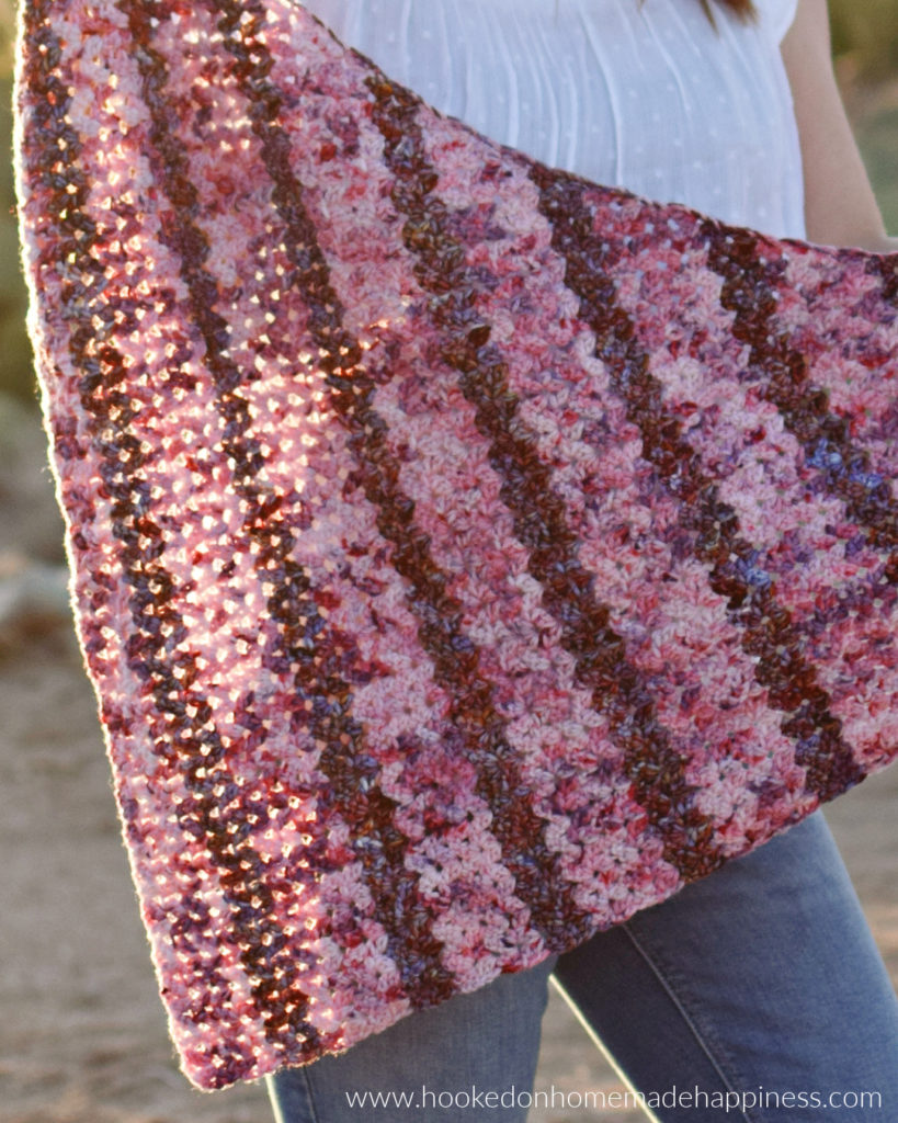 Petal Shawl Crochet Pattern - The Petal Shawl Crochet Pattern uses the pretty cluster V stitch. It creates such a pretty design that reminds me of petals. With just a simple 2 row repeat you can create this gorgeous shawl!