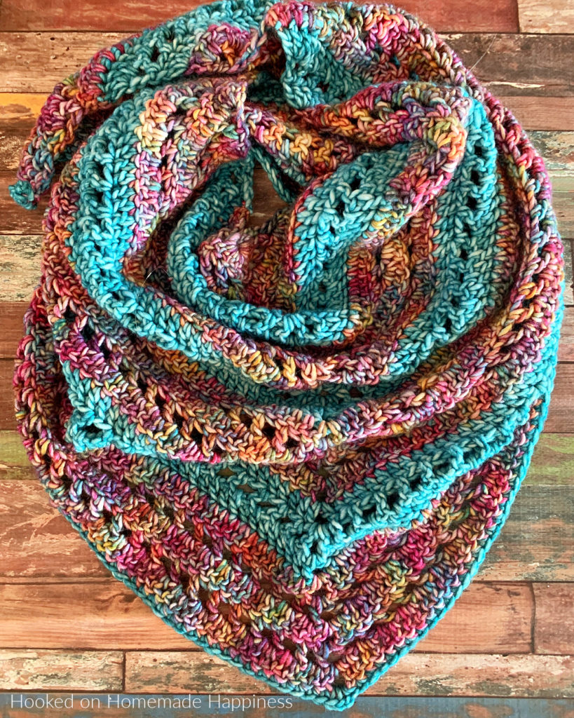 Stained Glass Triangle Wrap Crochet Pattern - The Stained Glass Triangle Wrap Crochet Pattern is a beginner level shawl. The only stitches needed are double crochet and chain stitch! I love how those two simple stitches can create such a pretty design.