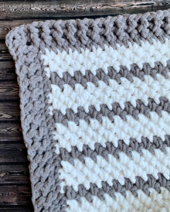 Braydon Baby Blanket Crochet Pattern - The Braydon Baby Blanket Crochet Pattern is an easy & quick baby blanket. Because of the super bulky yarn and the 1 row repeat, I was able to make it in just a day!