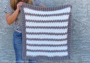 Braydon Baby Blanket Crochet Pattern - The Braydon Baby Blanket Crochet Pattern is an easy & quick baby blanket. Because of the super bulky yarn and the 1 row repeat, I was able to make it in just a day!