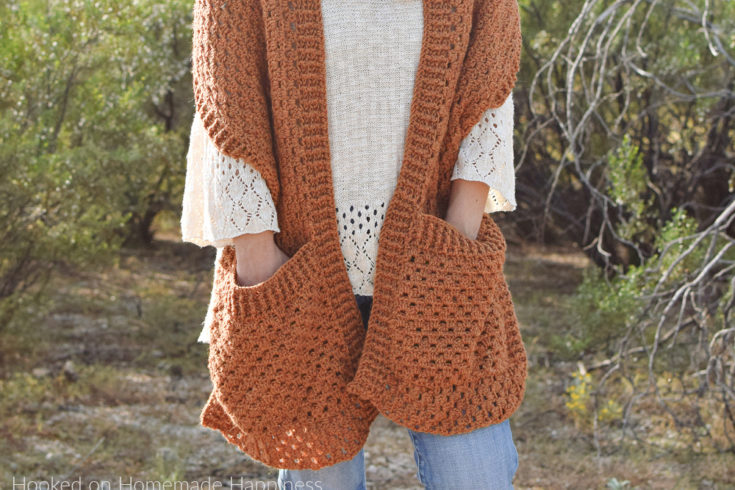 Persimmon Pocket Shawl Crochet Pattern - The Persimmon Pocket Shawl Crochet Pattern is the perfect pattern to get you ready for fall! It uses the classic granny stitch with a textured ribbing.