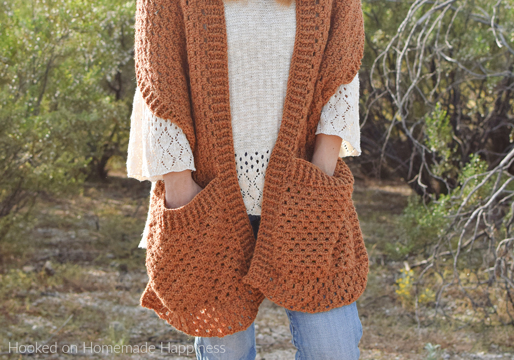 Persimmon Pocket Shawl Crochet Pattern - The Persimmon Pocket Shawl Crochet Pattern is the perfect pattern to get you ready for fall! It uses the classic granny stitch with a textured ribbing.