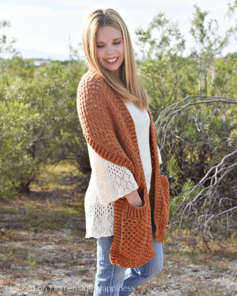 Persimmon Pocket Shawl Crochet Pattern - The Persimmon Pocket Shawl Crochet Pattern is the perfect pattern to get you ready for fall! It uses the classic granny stitch with a textured ribbing.