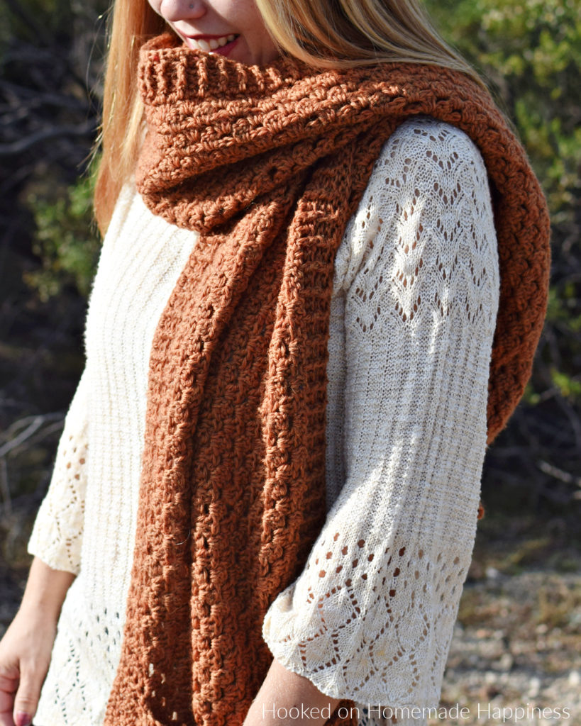 Persimmon Pocket Shawl Crochet Pattern - The Persimmon Pocket Shawl Crochet Pattern is the perfect pattern to get you ready for fall! It uses the classic granny stitch with a textured ribbing.