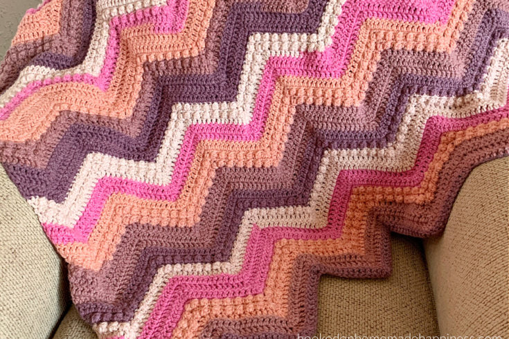 Raspberry Baby Blanket Crochet Pattern - The Raspberry Baby Blanket Crochet Pattern has a classic chevron stripe pattern with some fun berry stitches mixed in!