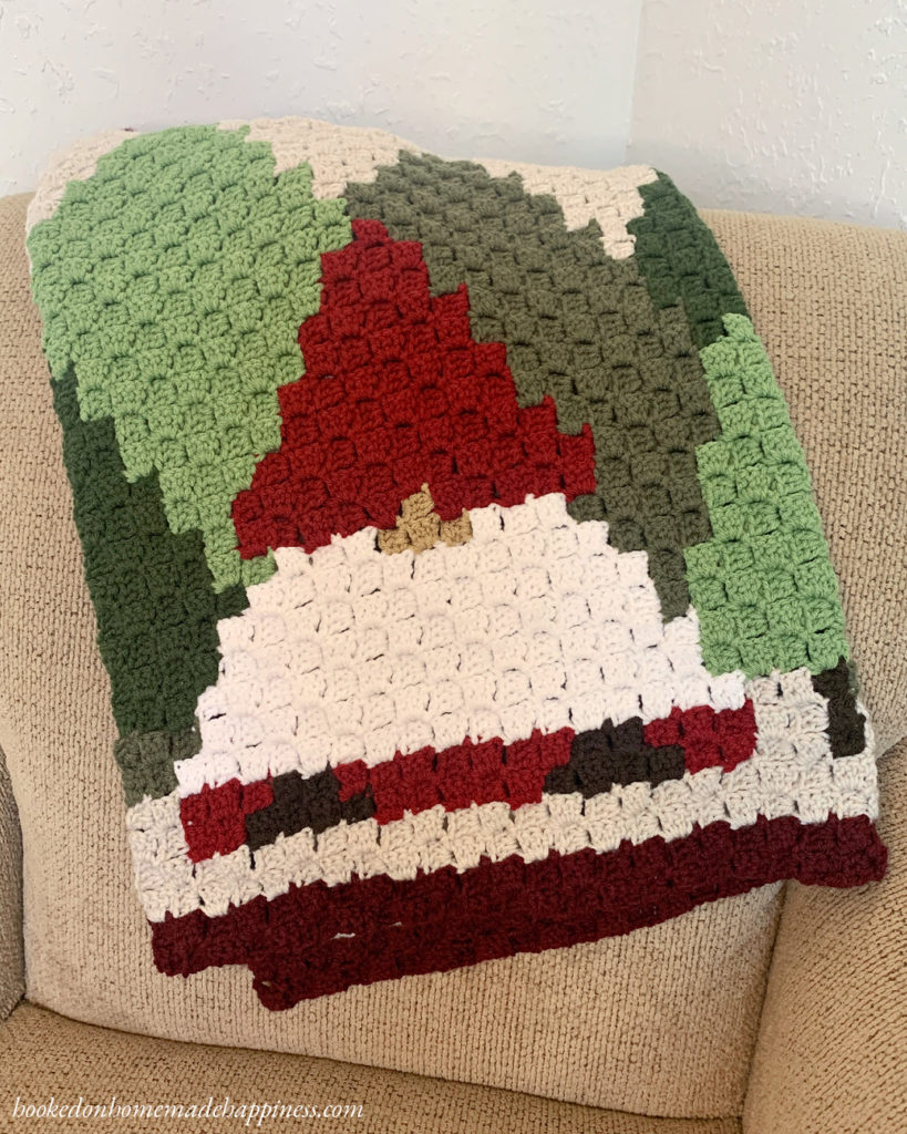 This Christmas Gnome Blanket C2C Crochet Pattern is so fun to work up! It's a small lapghan that's perfect for hanging over the back of a sofa. 