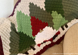 This Christmas Gnome Blanket C2C Crochet Pattern is so fun to work up! It's a small lapghan that's perfect for hanging over the back of a sofa.