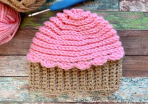 Cupcake Beanie Crochet Pattern - This Cupcake Beanie Crochet Pattern is just too cute! By using a few different crochet techniques this adorable baby beanie can be made in no time.