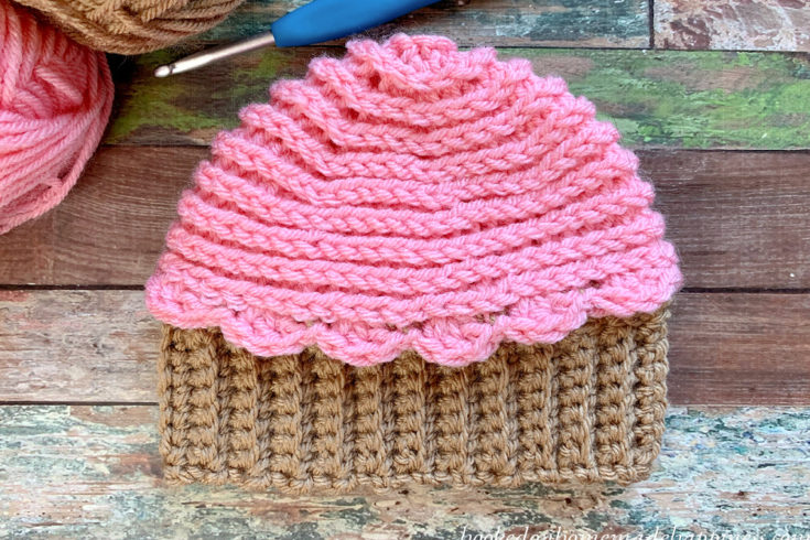 Cupcake Beanie Crochet Pattern - This Cupcake Beanie Crochet Pattern is just too cute! By using a few different crochet techniques this adorable baby beanie can be made in no time.