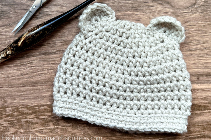 Baby Bear Beanie Crochet Pattern - The Baby Bear Beanie Crochet Pattern is a simple beanie pattern with cute little ears added. This beanie works up in no time! Perfect to add to your donation pile.