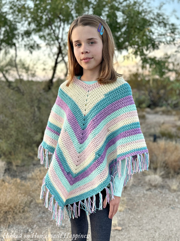 Easy All Double Crochet Kid's Hooded Poncho Crochet Pattern - The Easy All Double Crochet Kid's Hooded Poncho Crochet Pattern is a beginner level poncho that would be perfect for gifts! This easy pattern features a hood and fringe for some added cuteness.