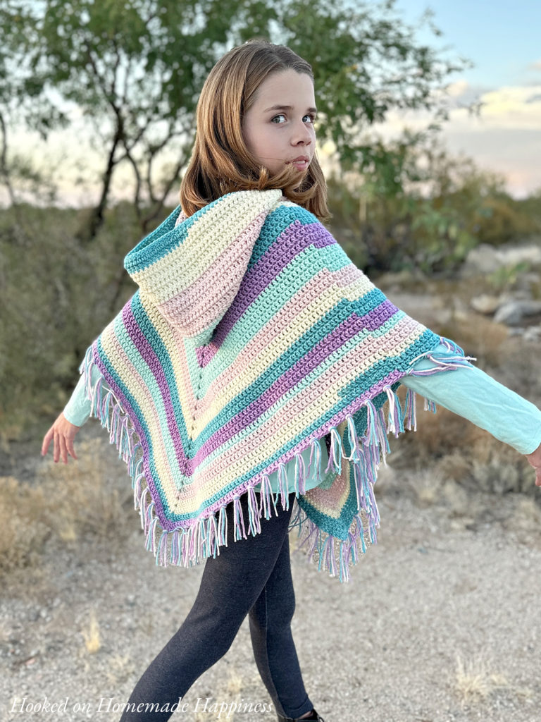 Easy All Double Crochet Kid's Hooded Poncho Crochet Pattern - The Easy All Double Crochet Kid's Hooded Poncho Crochet Pattern is a beginner level poncho that would be perfect for gifts! This easy pattern features a hood and fringe for some added cuteness.